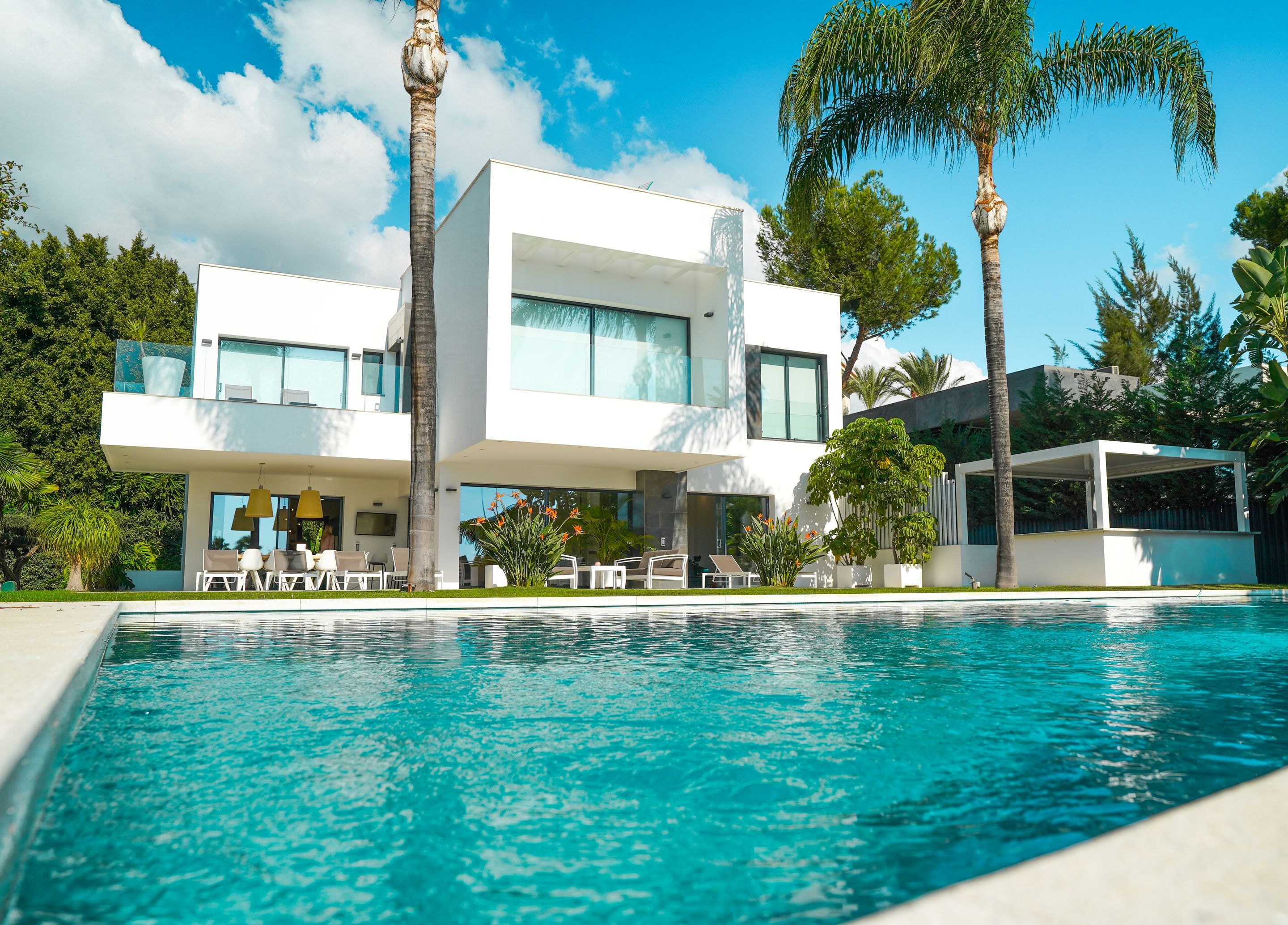 Contemporary white villa with pool and palms